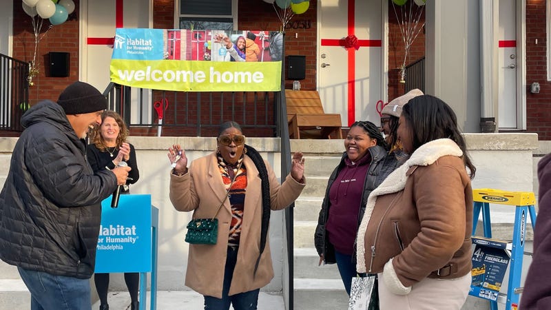 Four new homeowners celebrate at the Coltrane Commons development in Strawberry Mansion.