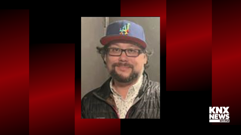 man with dark facial hair wearing glasses and baseball cap
