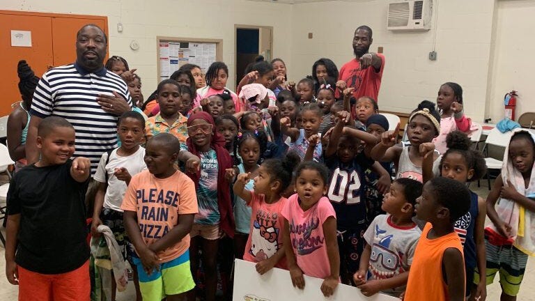 Tyrique Glasgow (background, red t-shirt) is executive director of Young Chances Foundation, a South Philadelphia service organization dedicated to helping city youth make good choices.