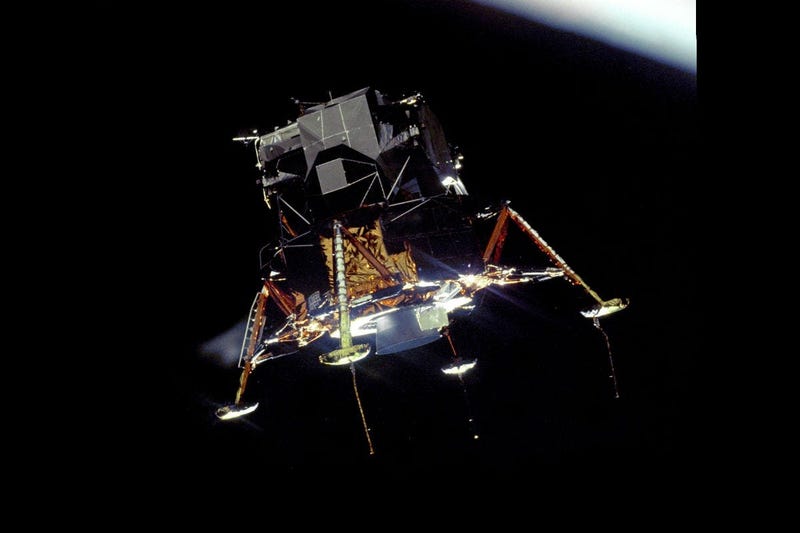 The Apollo 11 Lunar Module Eagle, in a landing configuration was photographed in lunar orbit from the Command and Service Module Columbia.