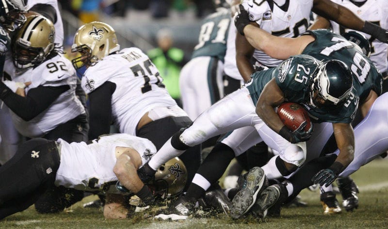 Philadelphia Eagles running back LeSean McCoy dives through the heart of the New Orleans Saints' defensive line to score a 1-yard touchdown in the third quarter during the NFC Wild Card Game on Saturday, Jan. 4, 2014, at Lincoln Financial Field.