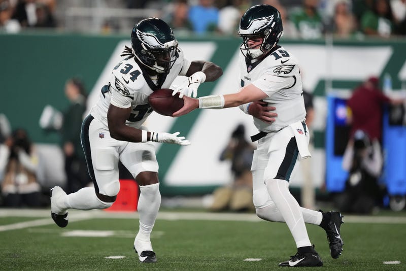 Philadelphia Eagles quarterback Kyle McCord (19) hands off to running back Montrell Johnson Jr. (34) in the first half of a preseason NFL football game in East Rutherford, N.J., Friday, Aug. 22, 2025.