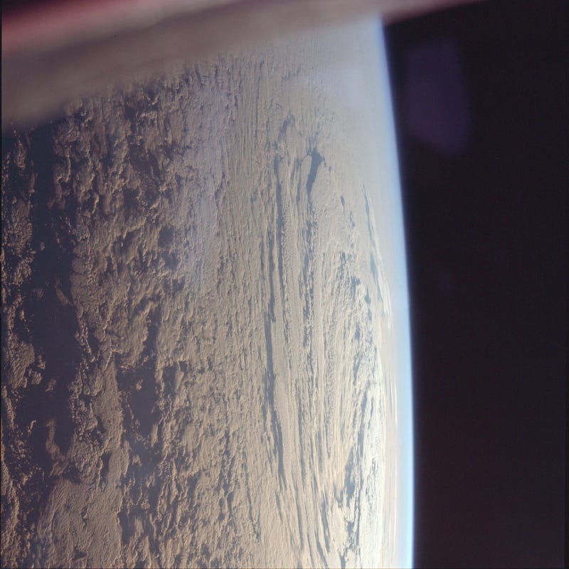 Astronaut Michael Collins took this photo of the cloud-speckled Earth, looking east towards the Sun.