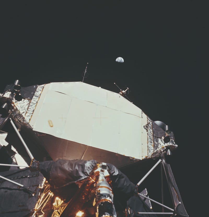 The Lunar Module or 'Eagle' on the Moon with the Earth visible behind it.
