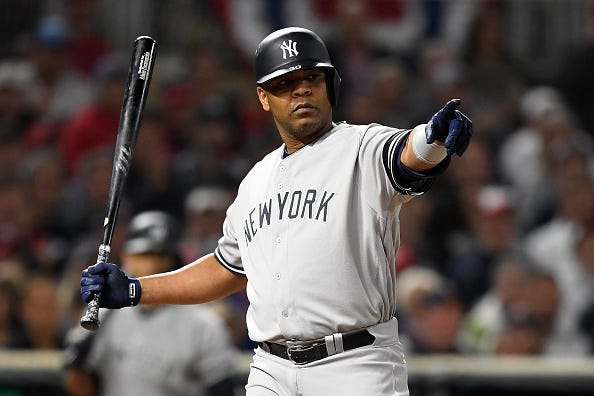 Edwin Encarnacion checks his swing with an umpire. 