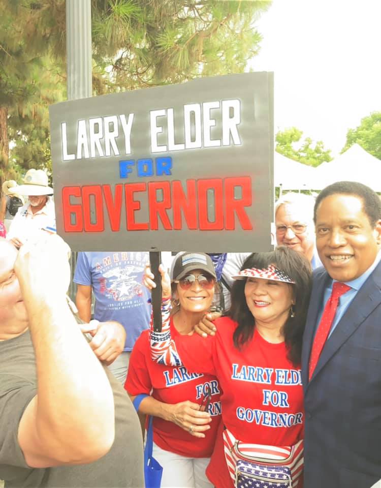 California governor recall candidate Larry Elder posing with fans.