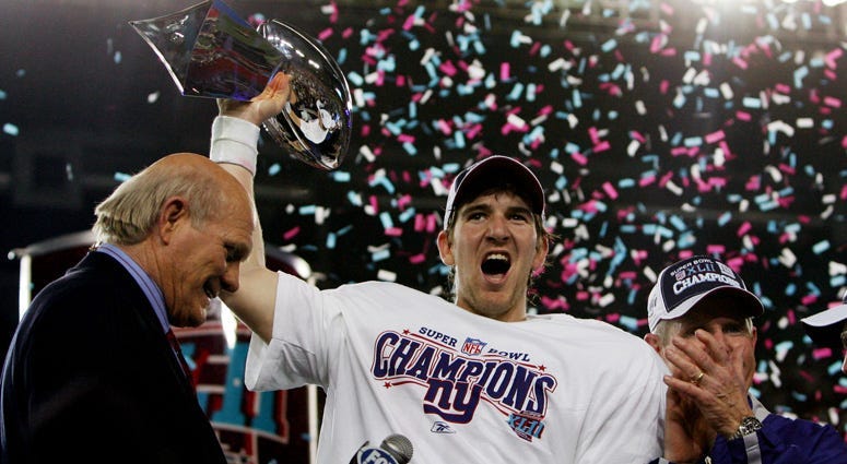 Giants quarterback Eli Manning holds the Vince Lombardi Trophy after defeating the New England Patriots 17-14 in Super Bowl XLII on Feb. 3, 2008, at University of Phoenix Stadium in Glendale, Arizona.