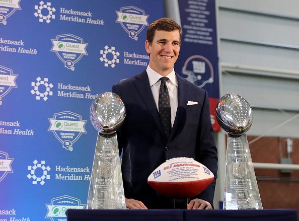 Eli Manning stands with his two Super Bowl trophies during his retirement announcement.