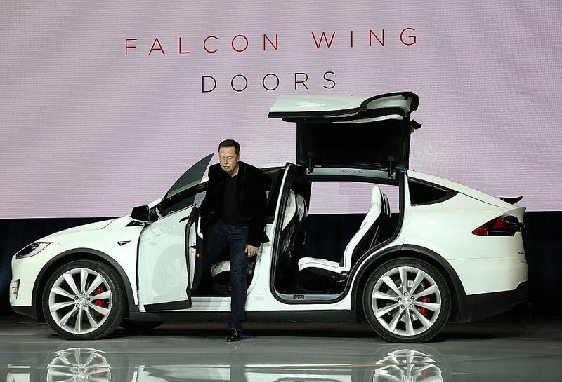 Tesla CEO Elon Musk demonstrates the falcon wing doors on the new Tesla Model X Crossover SUV.
