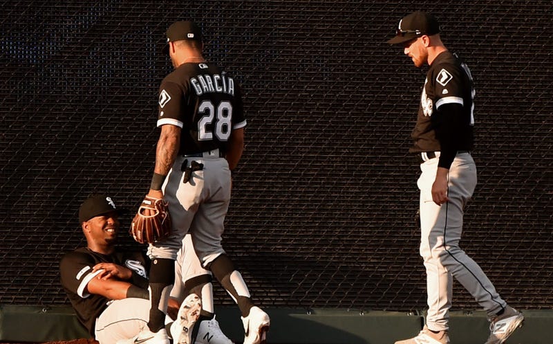 Eloy Jimenez, left, reacts after colliding with White Sox teammate Charlie Tilson.