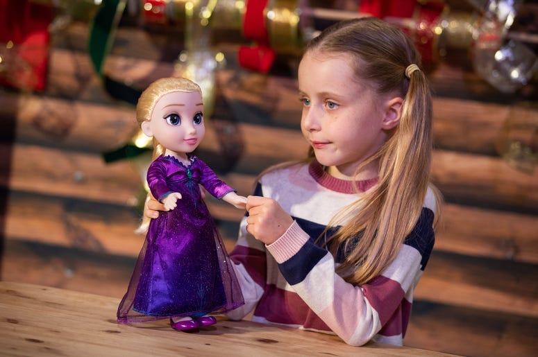 Girl plays with Frozen Elsa doll