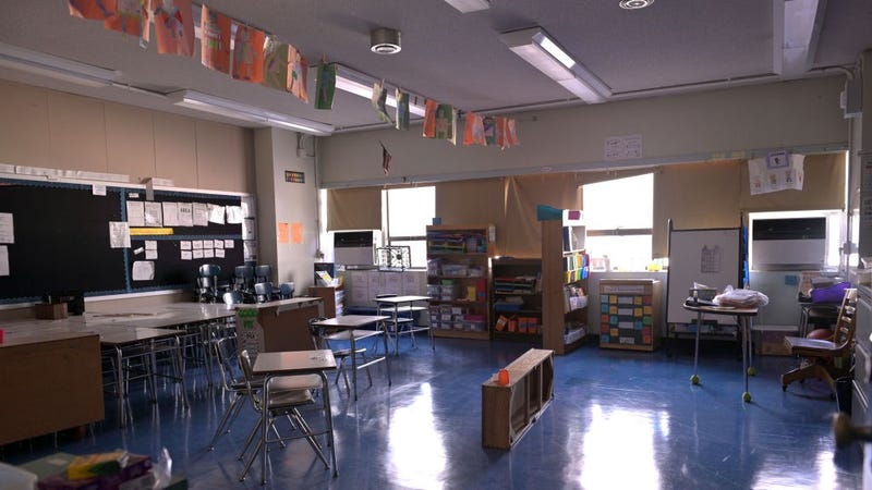 A classroom is empty with the lights off on what would otherwise be a blended learning school day on November 19, 2020 at Yung Wing School P.S. 124 in New York City.