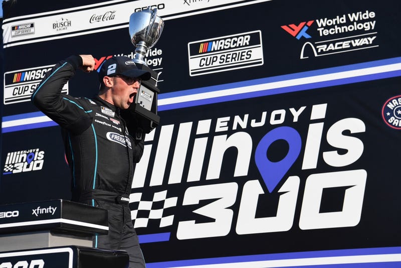 Team Penske’s Austin Cindric celebrates with the winner’s trophy in Victory Lane after claiming last season’s Enjoy Illinois 300 NASCAR Cup Series race at World Wide Technology Raceway. 