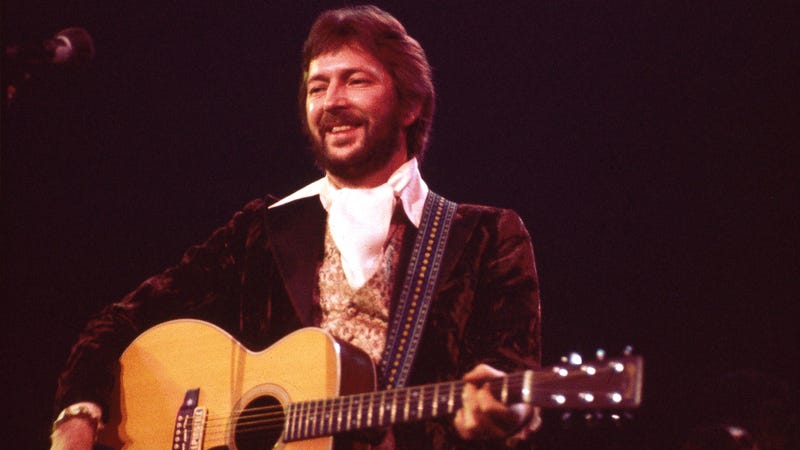 Eric Clapton performs live on stage playing a Martin acoustic guitar at Hammersmith Odeon in Hammersmith, London on 27th April 1977.