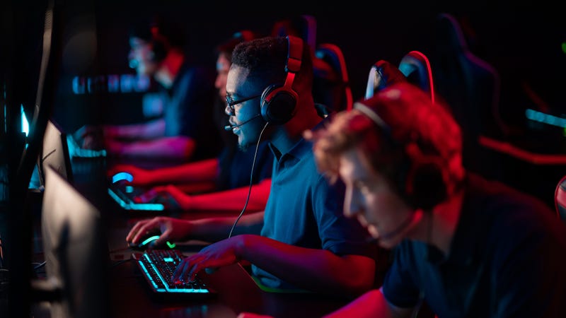 Young men at computers compete in an Esports tournament