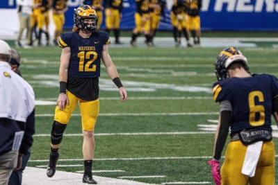 Brock Vandagriff's knee brace he has worn over the last half of the season is clearly visible warming up for Monday's Class A state championship game.