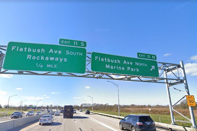 The sign for the exit near where an unidentified man was found dead in a burning homeless encampment.