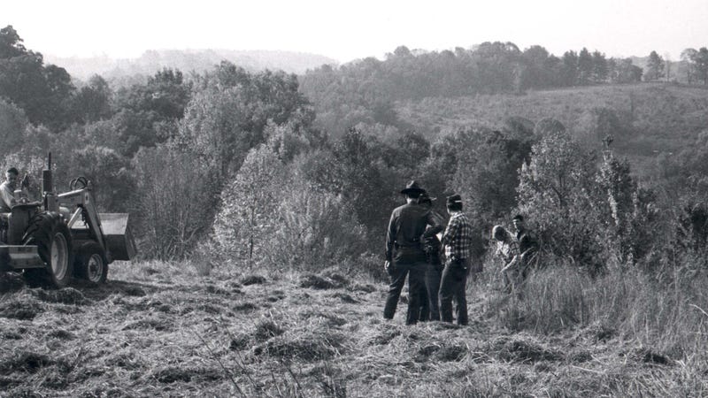 People search near the spot where Gretchen Harrington's remains were found two months after her murder.