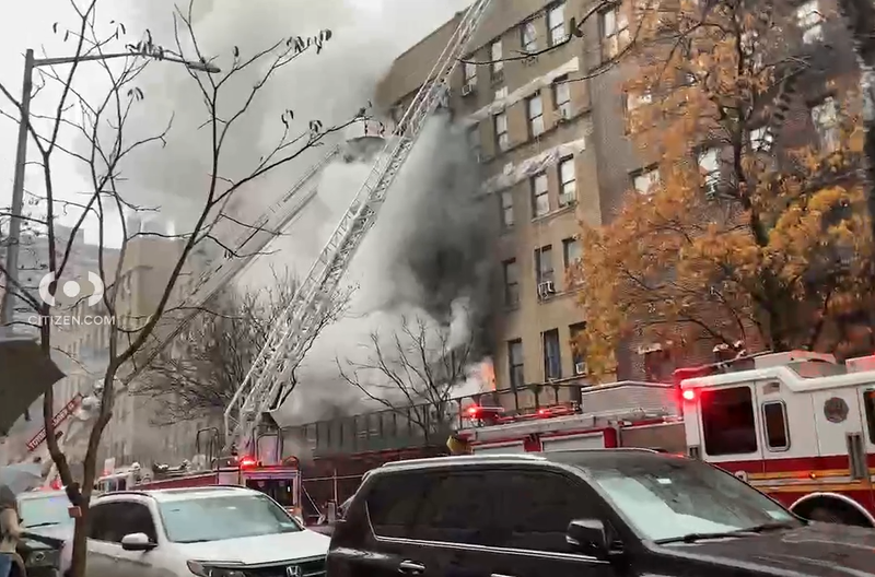 Flames and smoke were seen pouring out of the building on West 204th Street in Inwood