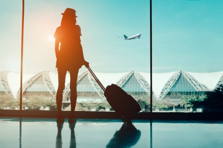 Silhouette woman travel with luggage looking without window at airport terminal international or girl teenager traveling in vacation