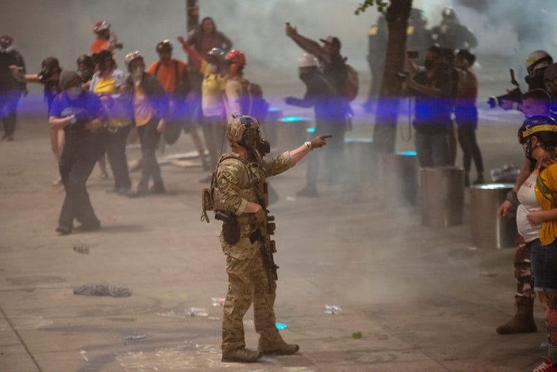 A federal officer points to a protester while clearing a street in Portland, July 20, 2020