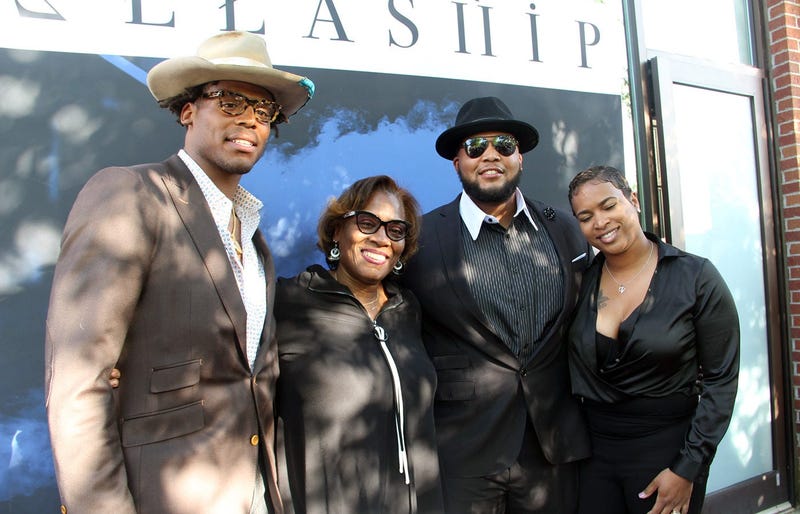 Cam Newton and family outside the grand opening of his Fellaship lounge in Atlanta