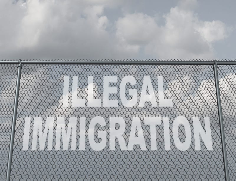 chain fence with a hole shaped as text that represents people illegally crossing a national border violating the migration law of the country