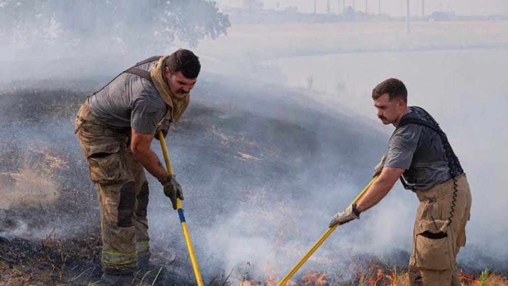 Fort Worth firefighters work for several days on a stubborn grass fire