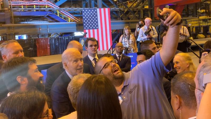 President Joe Biden pauses to take a selfie at Philly Shipyard after announcing the a contract to build a first-of-its-kind ship that will support construction of off-shore wind energy farms.