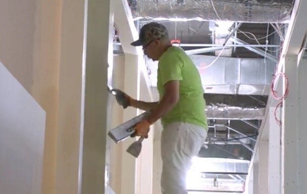 worker finishing walls 