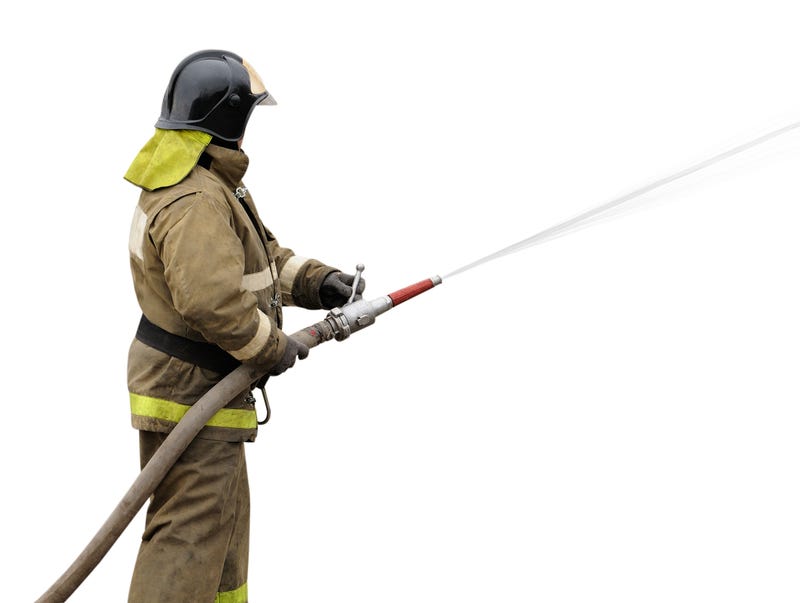Firefighter working with fog nozzle. Isolated on white background