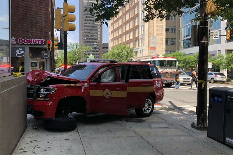 An eye witness tells me a woman trying to beat the light at 21st and Market slammed into this fire department vehicle, which hit a pedestrian before slamming into the building