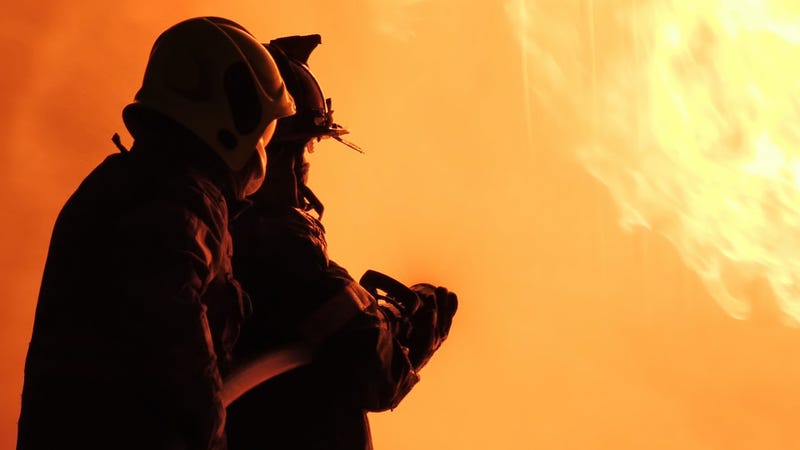 Firefighter spray water fighting - stock photo