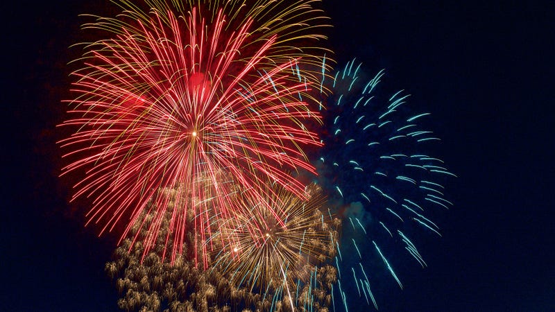 Background of colorful fireworks display in night sky - stock photo