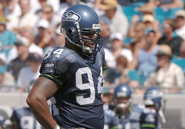 Bryce Fisher stands on the field with the Seattle Seahawks.