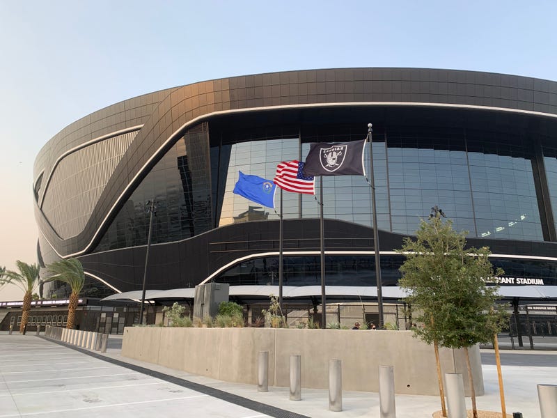 Flags fly outside of Allegiant Stadium
