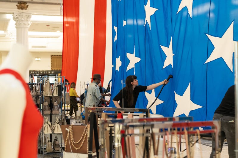 Giant American flag being unfurled in Macy's