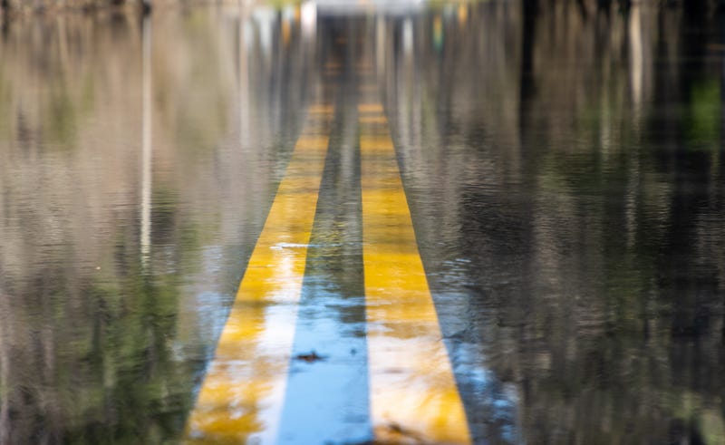flood water over double lines on road