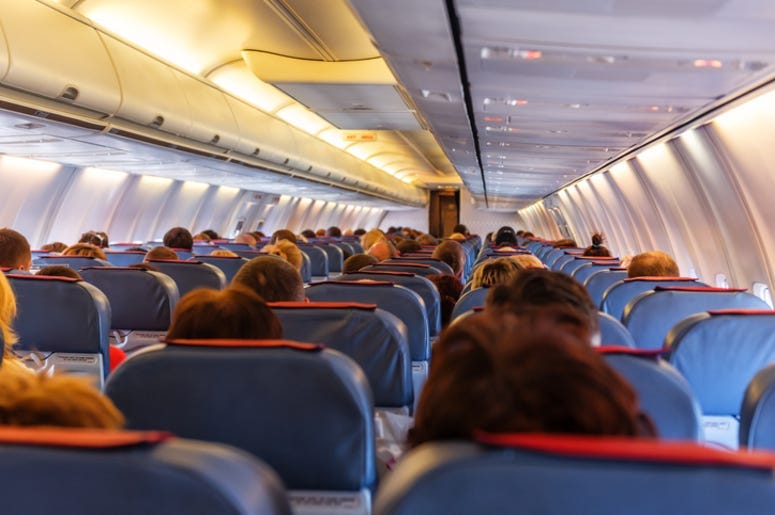 Interior of airplane with passengers in seats