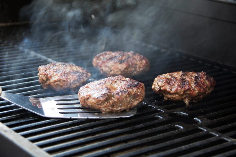 flipping burgers on a grill