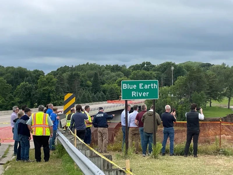 Officials including Governor Tim Walz examine the flooding damage on the Blue Earth River in southern Minnesota.
