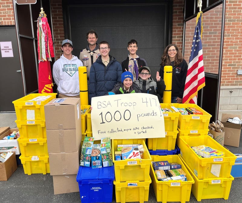 Boy Scouts with plastic bins of food