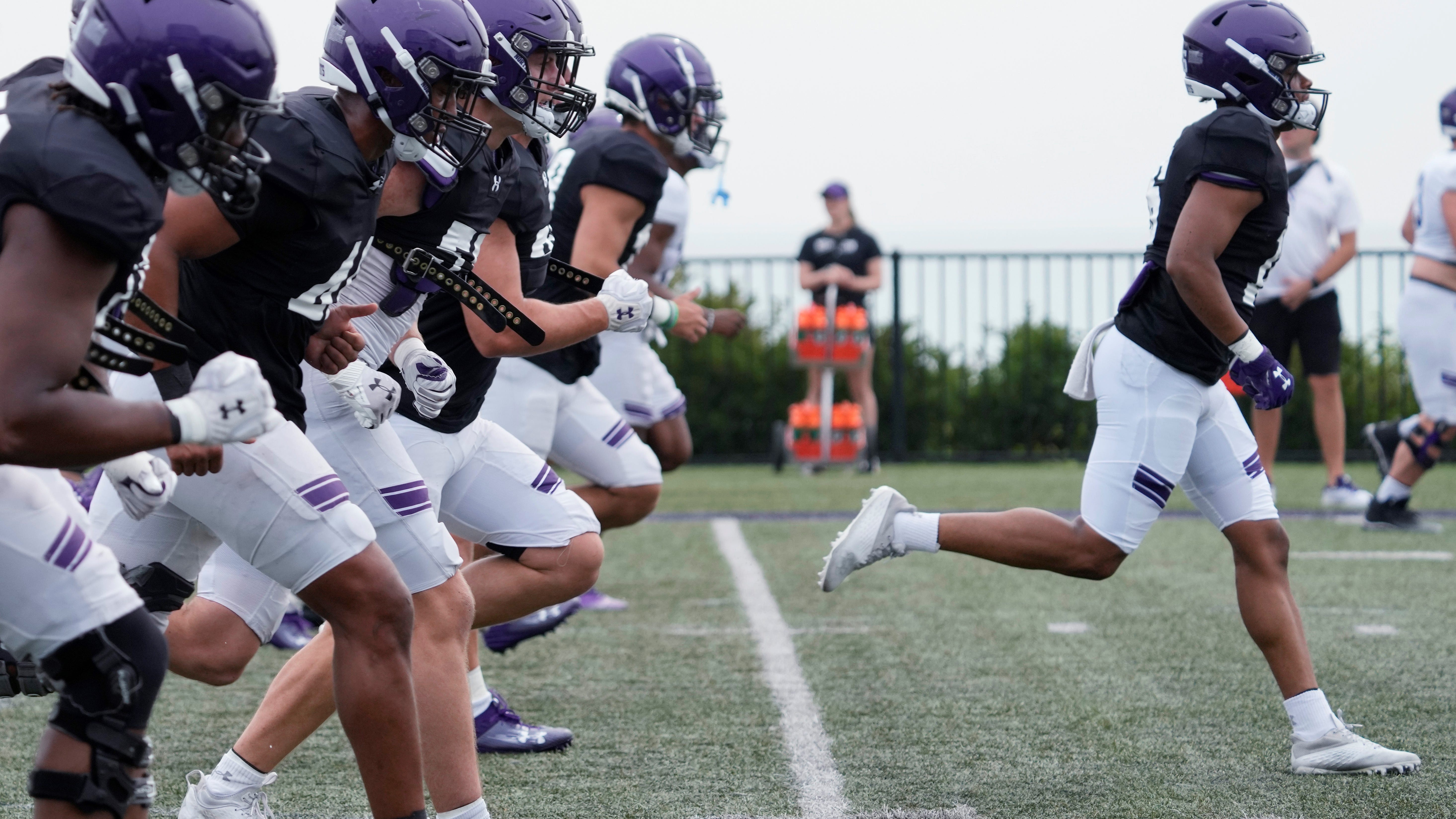 NU football practice overshadowed by defiant shirts worn by some assistant coaches