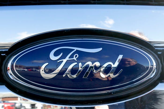 This Nov. 19, 2015 file photo shows the blue Ford oval badge in the grill of a pickup truck