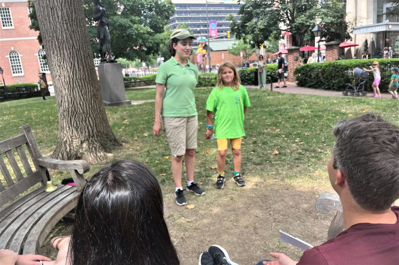 Once Upon a Nation storyteller Lucy Fletcher (left) watches as 9-year-old Franny tells seated visitors the story of Roger Arlener Young.