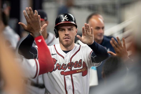 Freddie Freeman celebrates with teammates in the dugout. 