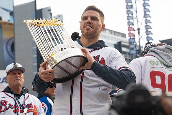 Freddie Freeman hoists the World Series trophy at the Braves parade. 