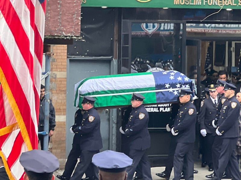 The casket of Officer Adeed Fayaz is carried during Thursday's procession