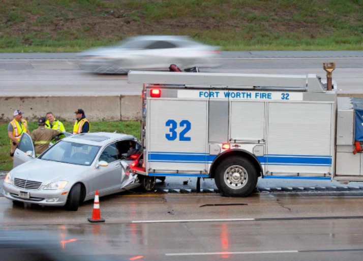 Driver skids on wet pavement, crashing into a Fort Worth fire truck