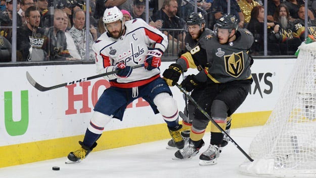 Capitals left wing Alex Ovechkin battles for the puck with Golden Knights defenseman Nate Schmidt (88) in the third period in Game 2 of the Stanley Cup Final on May 30, 2018, at T-Mobile Arena in Las Vegas.
